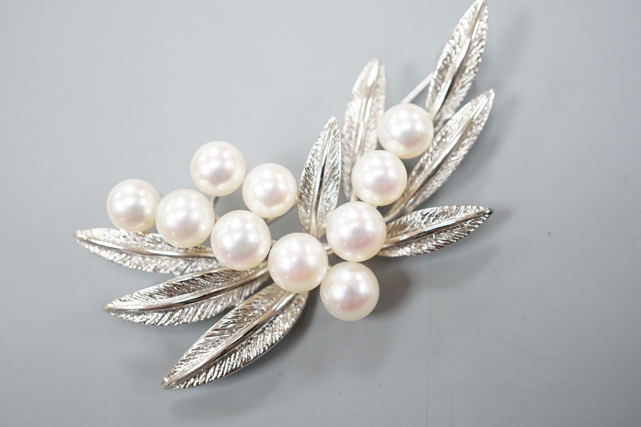 A Mikimoto cultured pearl cluster set metal spray brooch, 54mm.